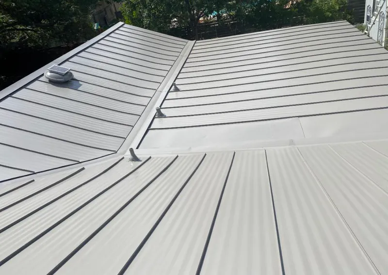 Solar attic fan installed on a metal roof for Roof Ventilation in Red Oak